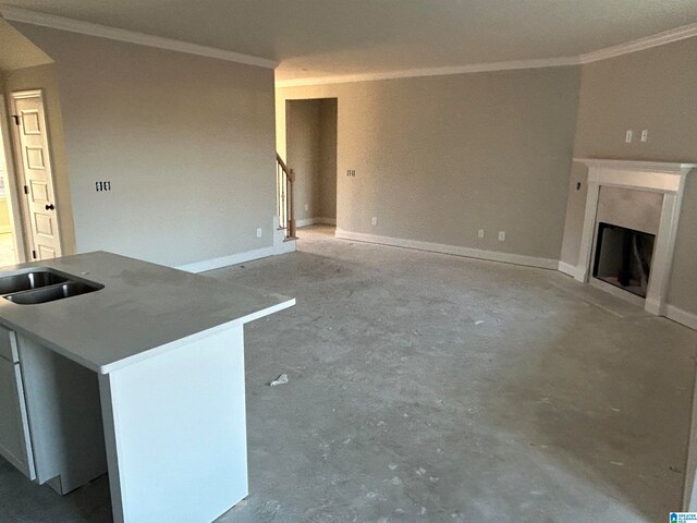 unfurnished living room with crown molding