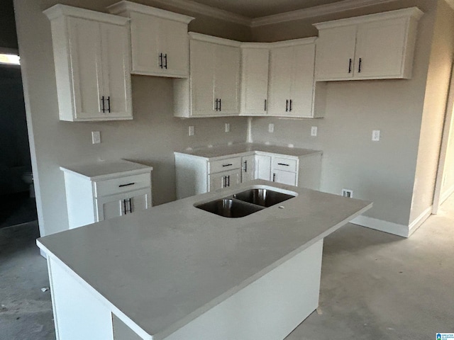 kitchen featuring white cabinets, concrete floors, and a kitchen island with sink