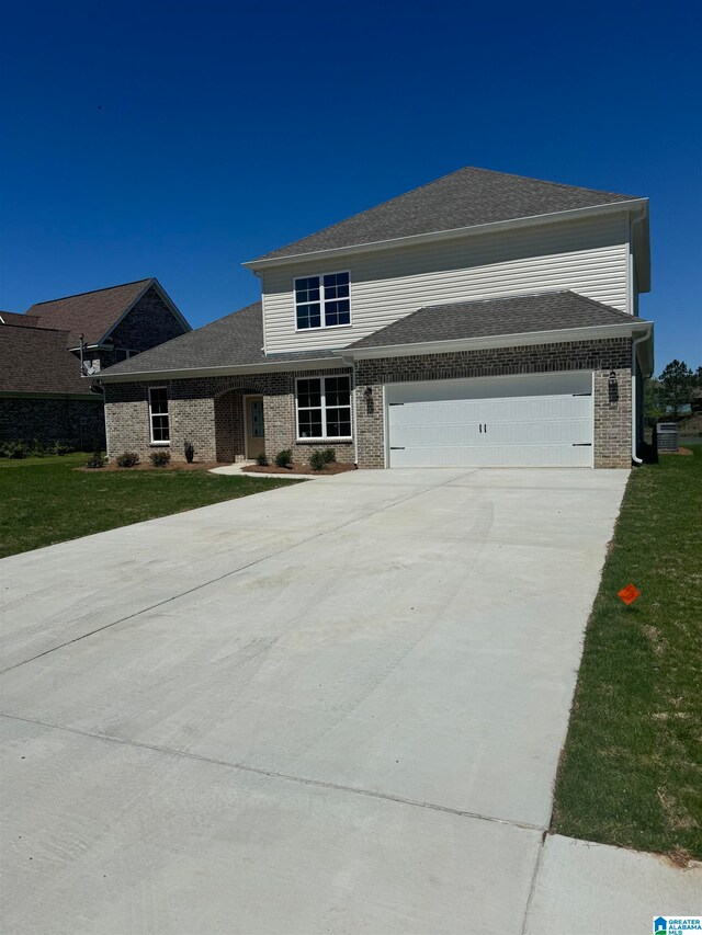 view of front of home with a garage and a front yard