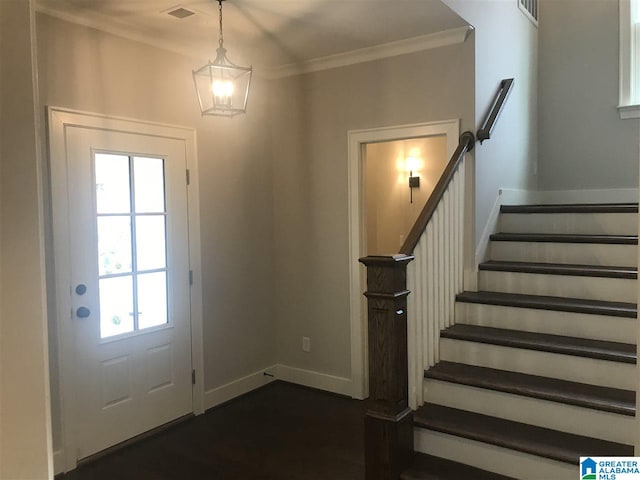 foyer entrance featuring ornamental molding