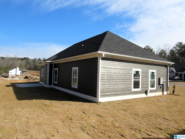 view of home's exterior featuring a lawn and a patio area