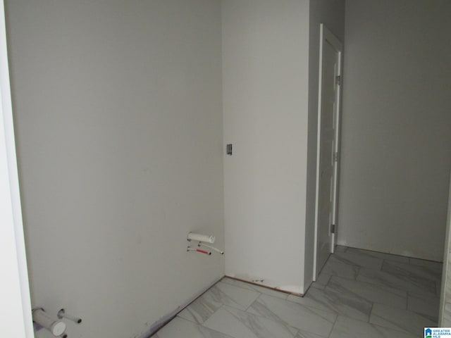 laundry area featuring light tile flooring