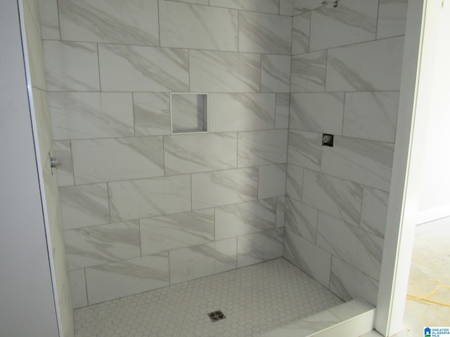 bathroom with tiled shower