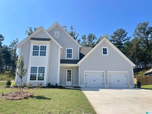 view of front of property featuring a garage and a front lawn