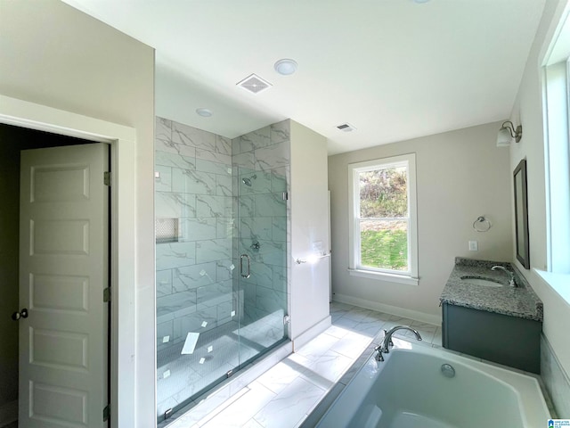 bathroom with vanity and shower with separate bathtub