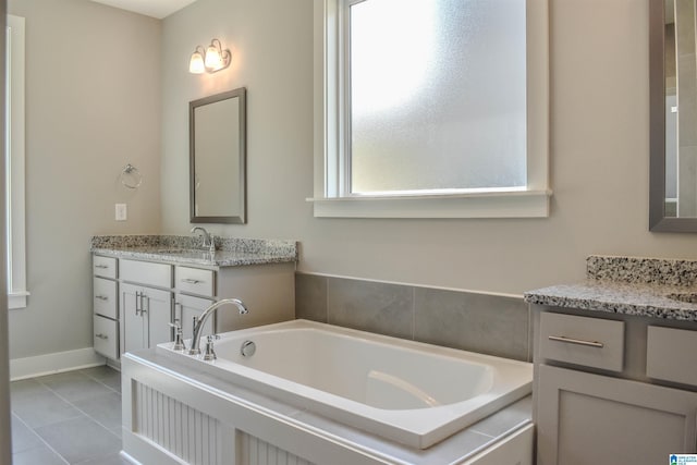 bathroom with vanity, tile patterned floors, and a tub