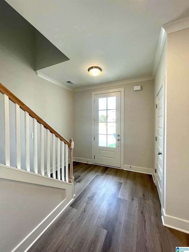 entryway with crown molding and dark wood-type flooring