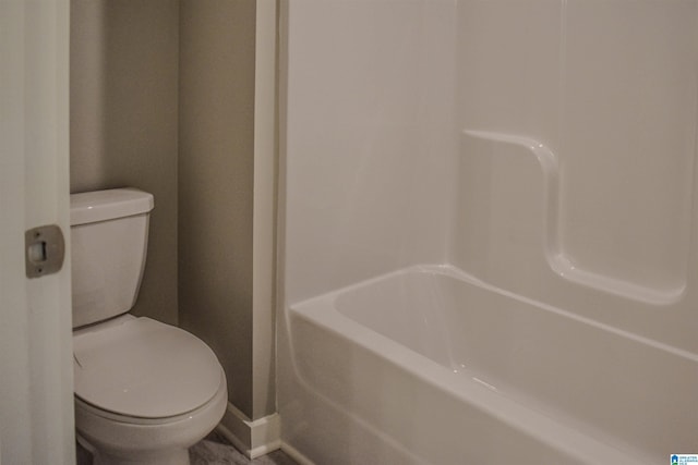 bathroom with a washtub and toilet