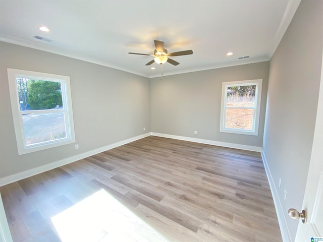 empty room with ornamental molding, ceiling fan, and light wood-type flooring