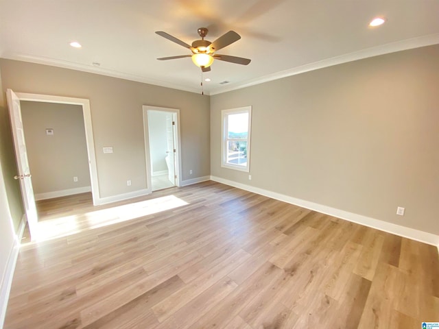 empty room with ornamental molding, ceiling fan, and light wood-type flooring