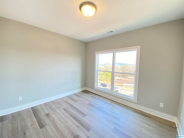 unfurnished room featuring light hardwood / wood-style flooring