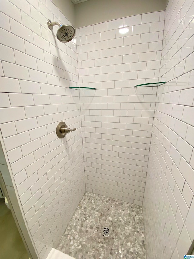 bathroom with a tile shower