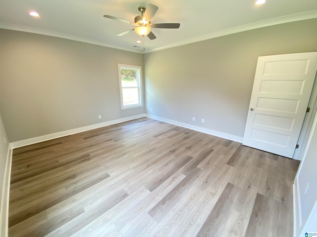 spare room featuring ornamental molding, light hardwood / wood-style flooring, and ceiling fan