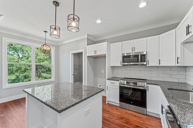 kitchen featuring dark wood-type flooring, white cabinets, and appliances with stainless steel finishes