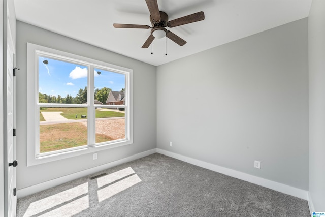 carpeted empty room featuring ceiling fan