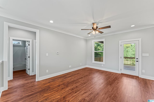 empty room with crown molding, dark wood-type flooring, and ceiling fan