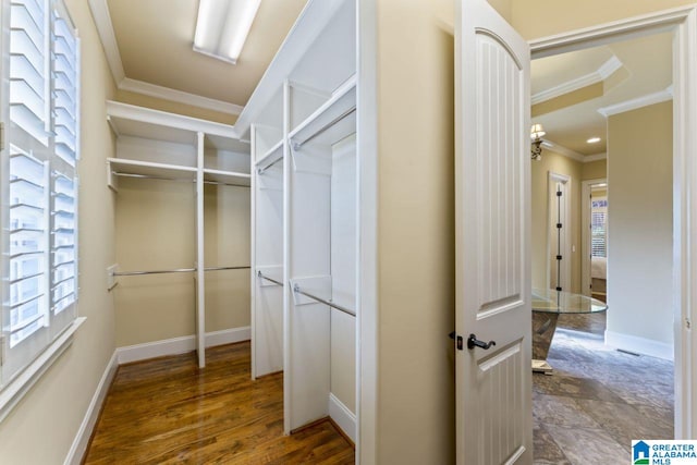 walk in closet featuring a chandelier and tile flooring