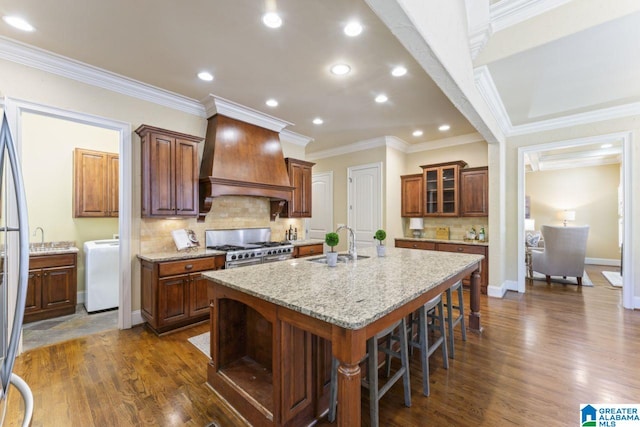 kitchen with backsplash, double oven range, dark hardwood / wood-style flooring, and custom exhaust hood