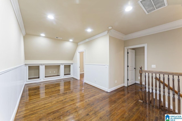 interior space featuring ornamental molding and dark hardwood / wood-style flooring