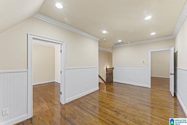 unfurnished room featuring dark hardwood / wood-style flooring, crown molding, and vaulted ceiling