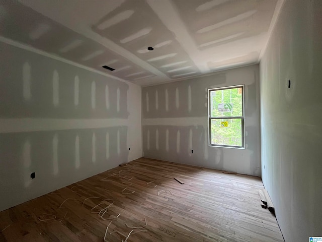 unfurnished room with hardwood / wood-style floors