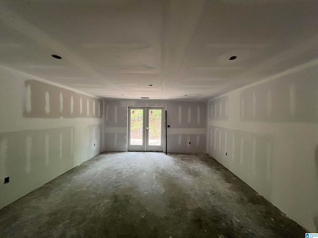 unfurnished room featuring concrete flooring and french doors