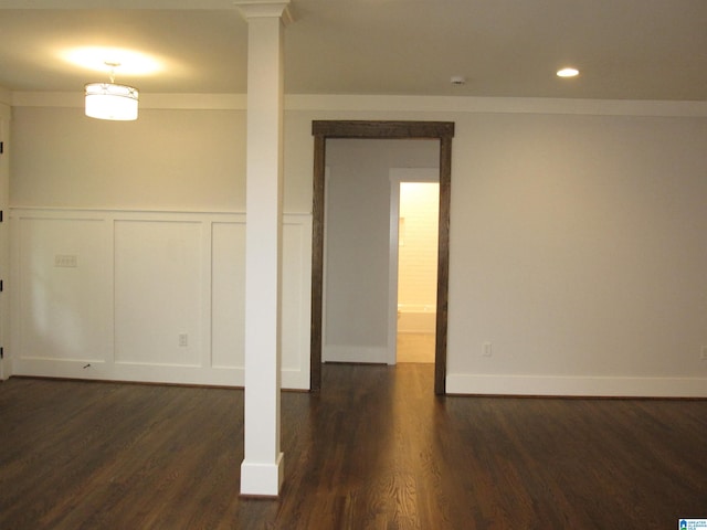 spare room featuring dark hardwood / wood-style floors and ornamental molding