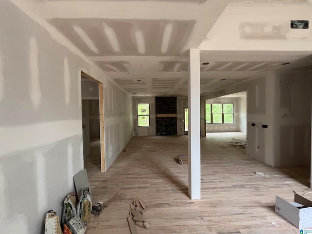 corridor featuring a wealth of natural light and light wood-type flooring