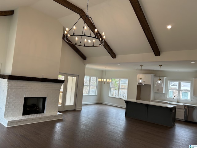 kitchen with dark hardwood / wood-style flooring, a center island, white cabinetry, and stainless steel dishwasher