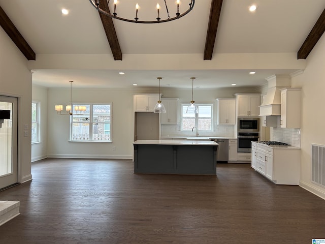 kitchen featuring white cabinets, dark hardwood / wood-style flooring, a kitchen island, and a notable chandelier