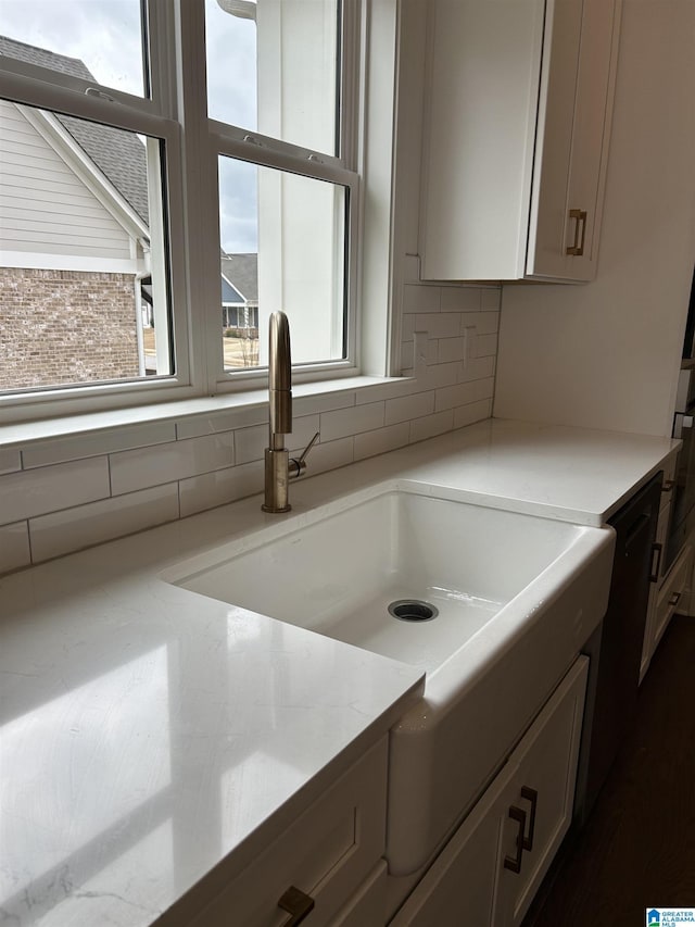 kitchen featuring a healthy amount of sunlight, sink, and backsplash