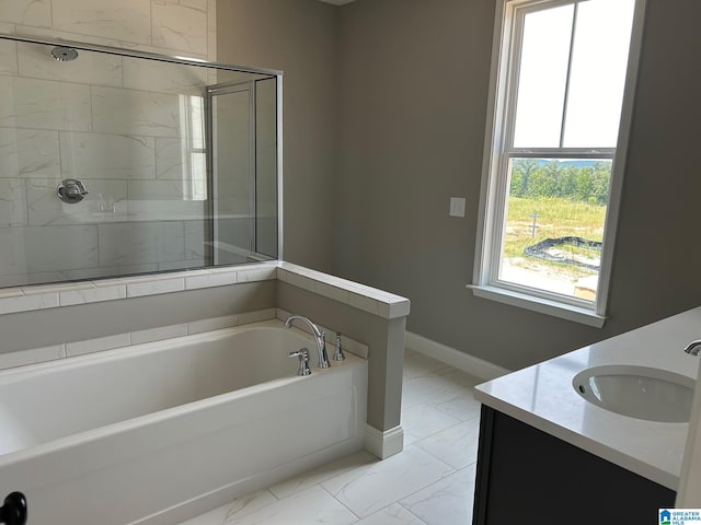 bathroom with vanity and shower with separate bathtub