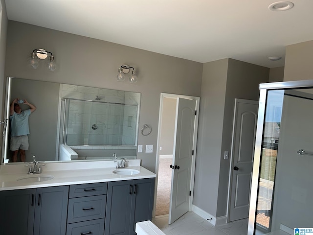 bathroom with vanity and a shower with shower door