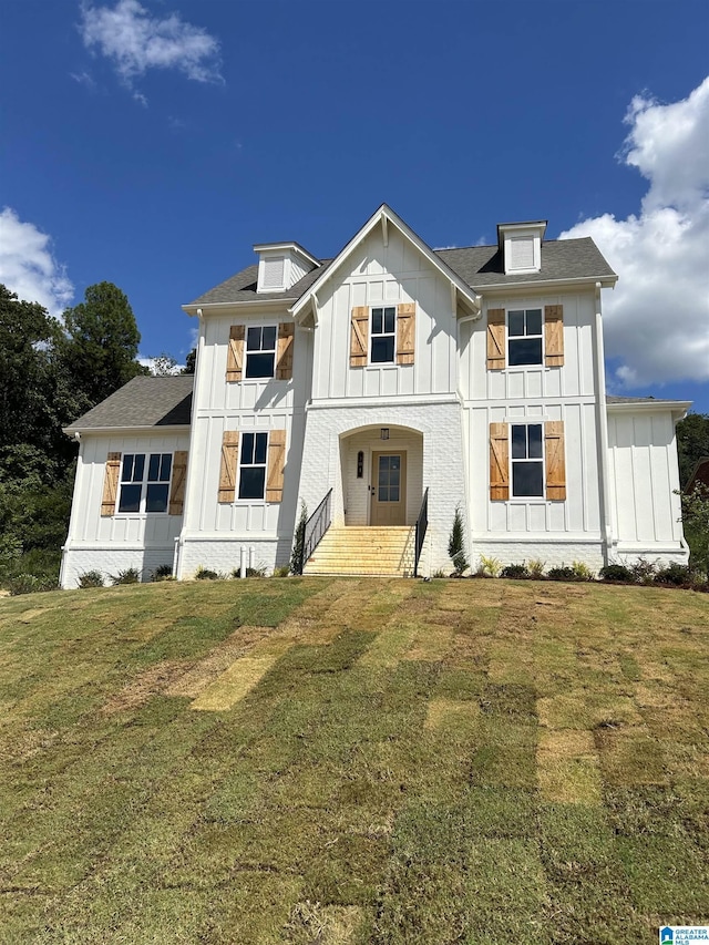 rear view of property with a lawn and covered porch