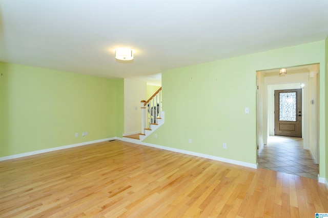 spare room featuring light wood-type flooring