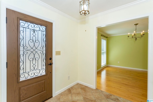 entrance foyer featuring crown molding, light wood-type flooring, and a chandelier