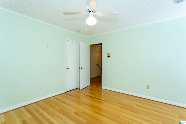 spare room with ceiling fan, ornamental molding, and hardwood / wood-style floors