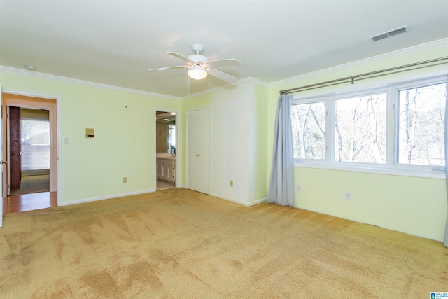 carpeted empty room featuring ornamental molding and ceiling fan