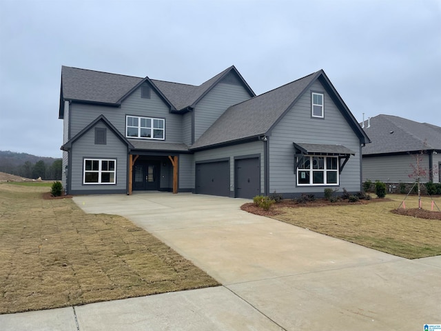 view of front of home with a garage and a front yard