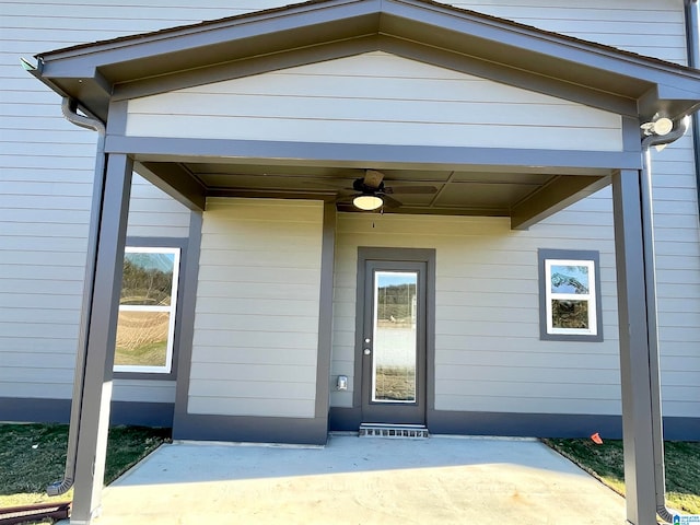 entrance to property featuring a patio area and ceiling fan