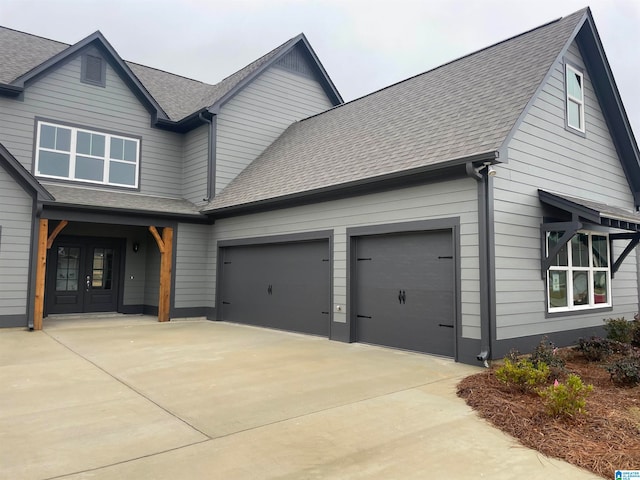 view of front of home with a garage and french doors