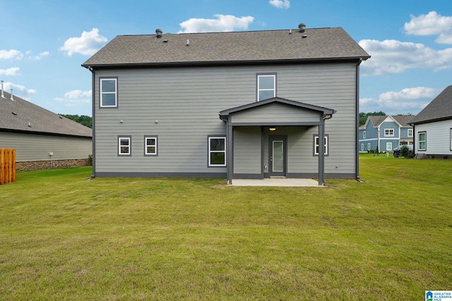 back of property featuring a patio area and a lawn