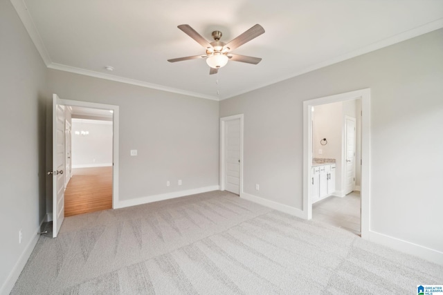 unfurnished bedroom with light carpet, ceiling fan, ornamental molding, and ensuite bath