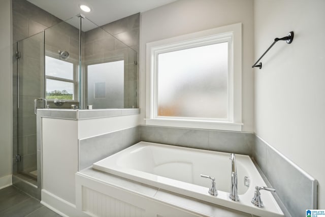 bathroom with tile patterned flooring and plus walk in shower