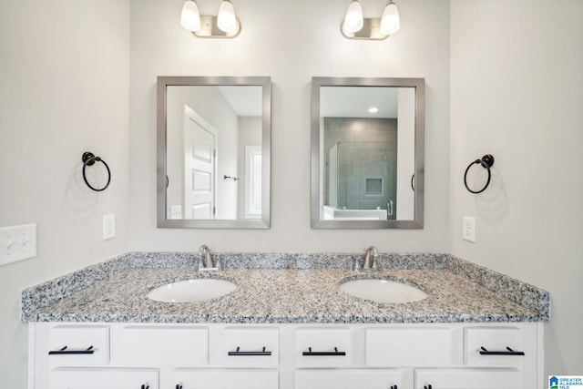 bathroom with walk in shower and vanity