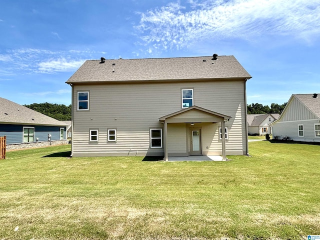 back of house featuring a patio area and a lawn