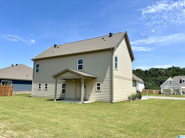 back of house featuring a yard and a patio