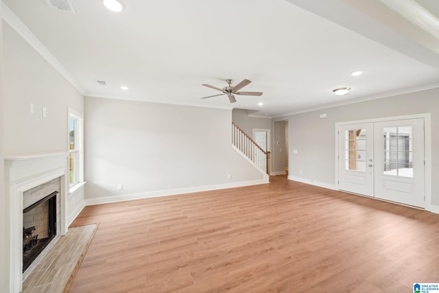 unfurnished living room featuring ceiling fan, crown molding, light hardwood / wood-style floors, and french doors