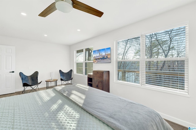 bedroom featuring a ceiling fan, baseboards, wood finished floors, and recessed lighting