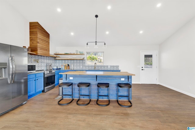 kitchen featuring tasteful backsplash, plenty of natural light, light wood-type flooring, and stainless steel appliances